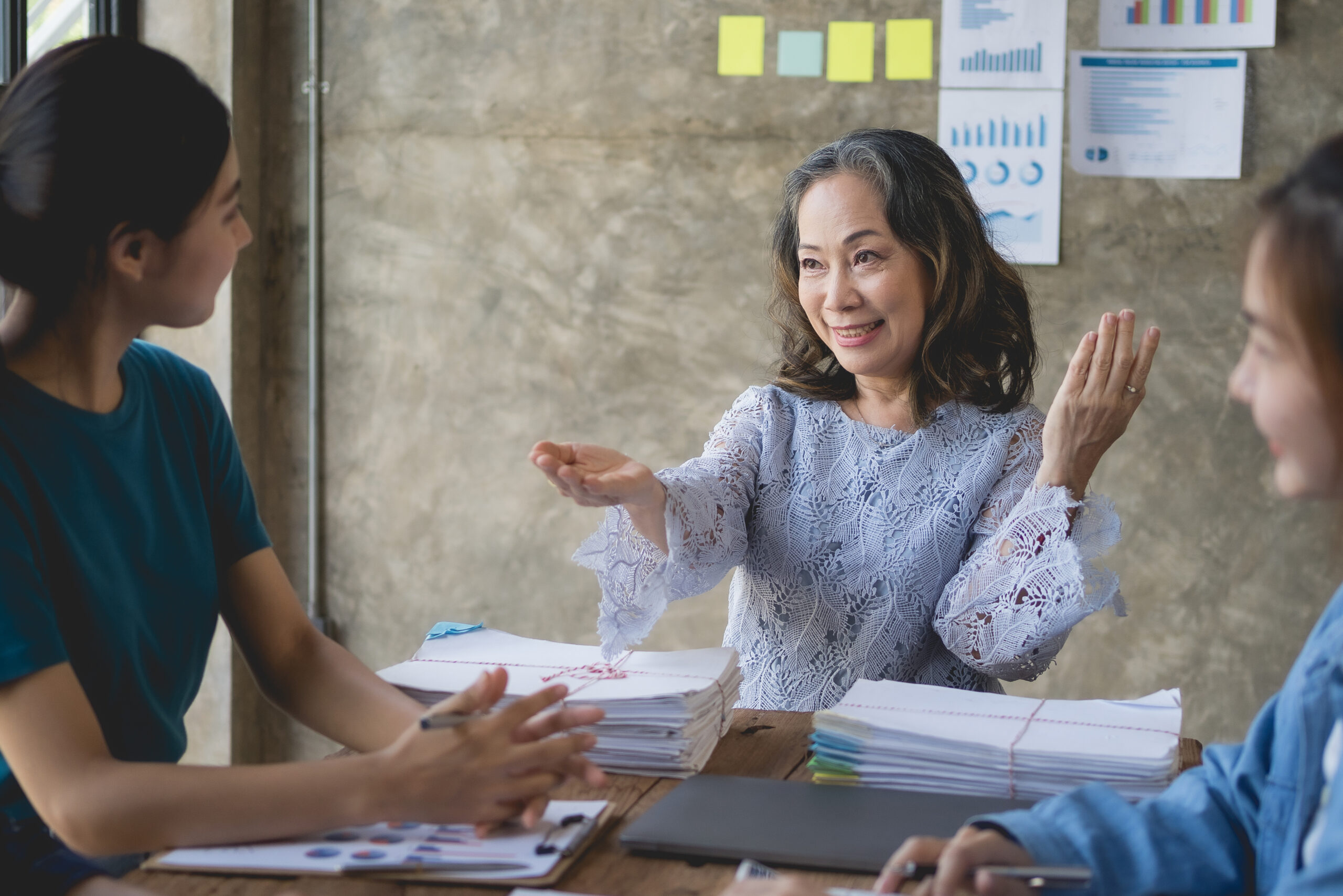 Asian business group holds consultations with senior supervisors on business planning, investment and market analysis for business development. There are various analytical documents and our laptops.